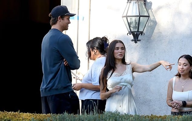 The singer and Los Angeles Chargers quarterback were pictured chatting between filming.